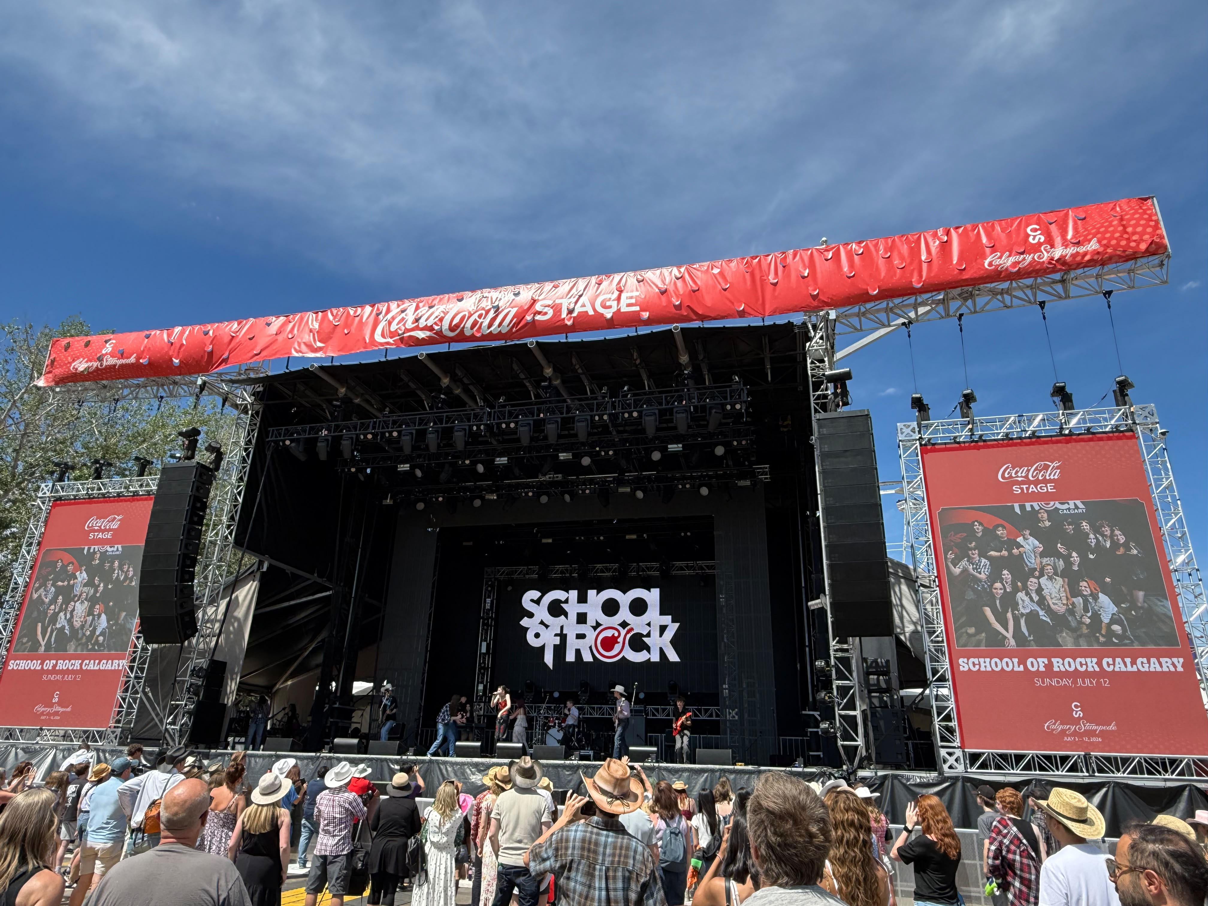 The audience watches School of Rock musicians on Calgary’s Coca-Cola Stage.